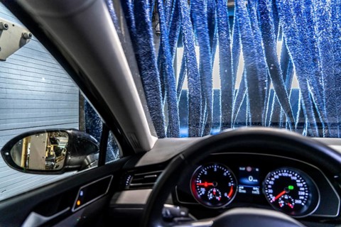 Car in an automatic car wash, car wash tunnel, drying, with hot air and rotating textile cloths
