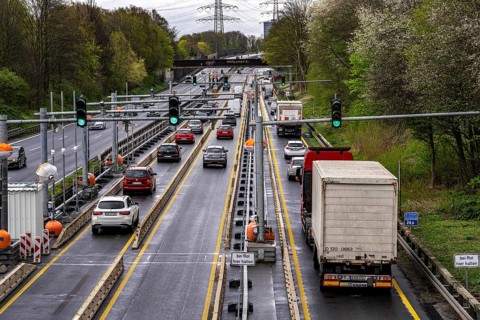 Weighing and barrier system on the A42 motorway, in front of the dilapidated motorway bridge over