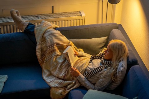 Symbolic image energy saving, cold winter, energy crisis, cold flat, mother and daughter lying on