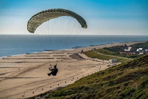 Paragliders along the dunes of Zoutelande, in Zeeland, South Holland, Netherlands