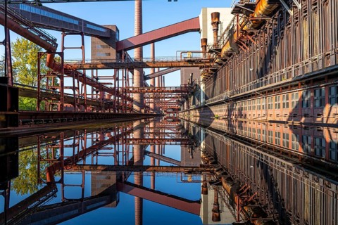 Zollverein coking plant, coke ovens, chimneys and conveyor bridges are reflected in the water