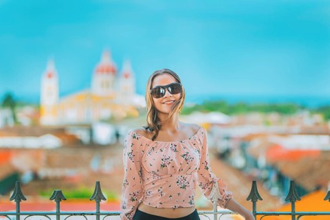 Happy young woman on vacation in Granada city, Nicaragua. Portrait of a beautiful tourist girl with