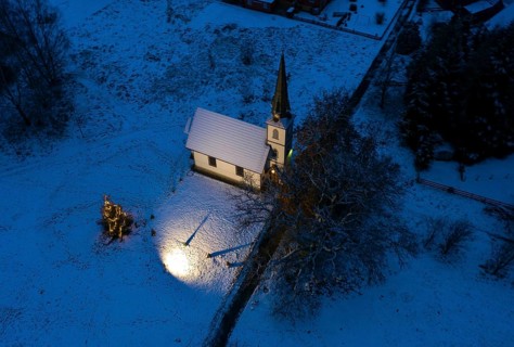 A Christmas tree stands in front of the smallest wooden church in Germany, Elend, 29 December 2020