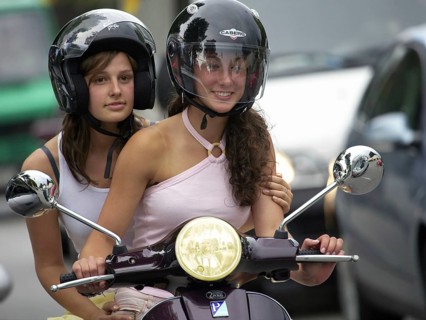 Two woman riding a scooter, Barcelona, Spaina