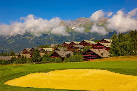 Crans Sur Sierre Golf Course with House and Mountain View in Crans Montana in Valais, Switzerland,