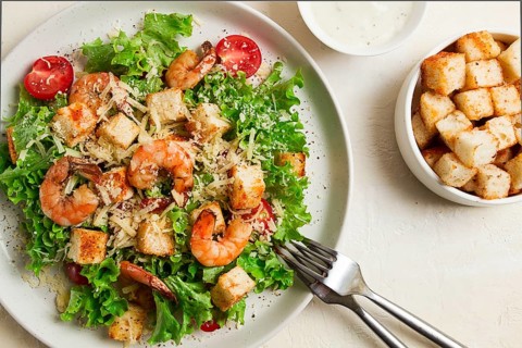 Caesar salad, with shrimp, on a white background, homemade, no people