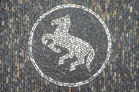 Jumping horse as a floor mosaic in Freiburg's historic city centre, Freiburg im Breisgau,