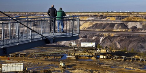 Two men on the Jackerath viewing platform look out over the Garzweiler open-cast lignite mine,