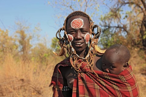 South Ethiopia, in Maco National Park, Mursi tribe, Mursi woman with baby, painted skin and