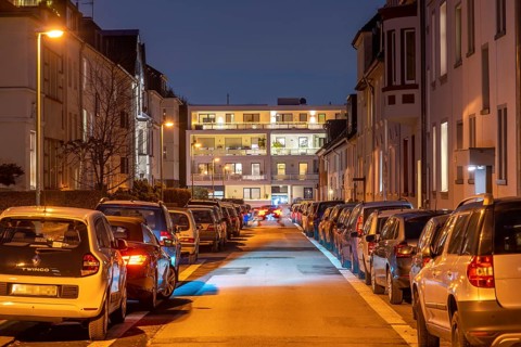 Residential street, many apartment buildings in a residential neighbourhood, evening, lantern