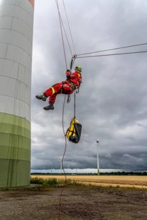 Height rescuers from the Oberhausen fire brigade practise abseiling from a wind turbine from a