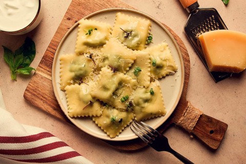 Ravioli with spinach and cheese, vegetarian food, on a beige background, no people.selective focus,