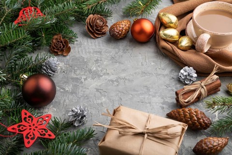 Christmas or New Year frame composition. Decorations, cones, cinnamon, fir and spruce branches, cup