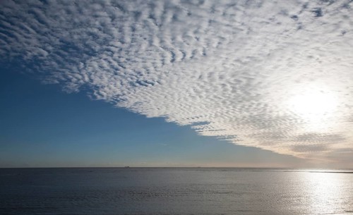 A mackerel sky or buttermilk sky of altocumulus clouds over Shingle Street, Suffolk, England,