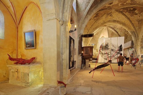 Art exhibition in the church Sainte-Marie de l'Assomption, interior view, visitors,