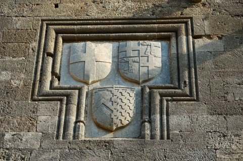 Relief with three coats of arms in a rectangular stone frame on a medieval wall, Knights' Street,