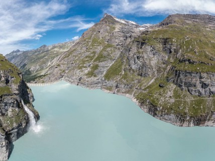 Panorama aerial view of lake Mauvoisin, artificial channels in the rock fill the lake, valley Val