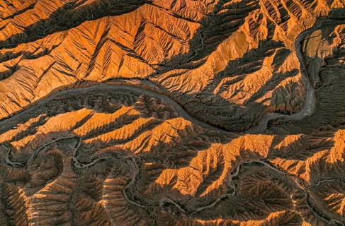 Landscape of eroded hills, top-down, badlands at sunset, aerial view, Canyon of the Forgotten
