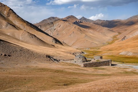 Historic caravanserai Tash Rabat from the 15th century, with yellow hills, Atbashy district in the