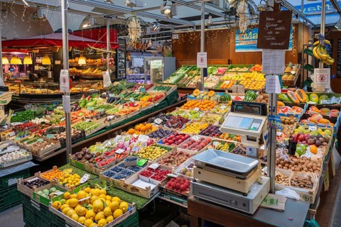 Market stall with a wide range of different tropical fruits and vegetables in the Markthalle