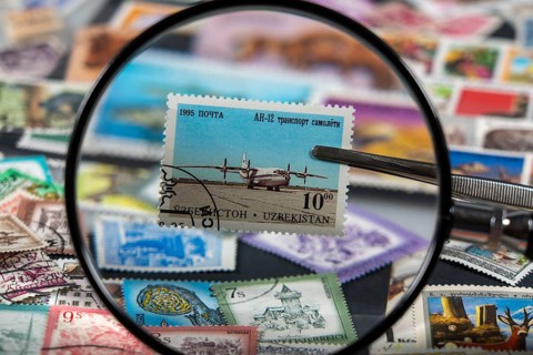 Stamp collection, collecting, postage stamps, postage stamps from different countries, magnifying