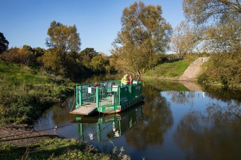 Cyclist, cycle tour, manually operated ferry across the Lippe near Halten am See, on the