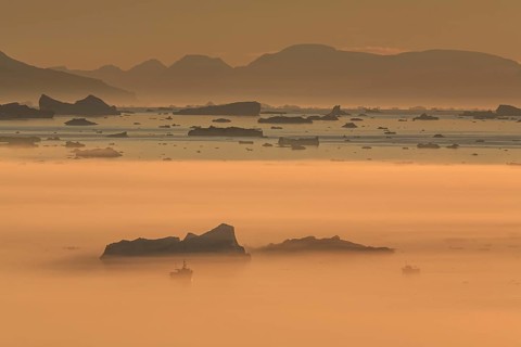Boats in front of icebergs in the fog, midnight sun, summer, Ilulissat, Ilulissat Icefjord, Disko