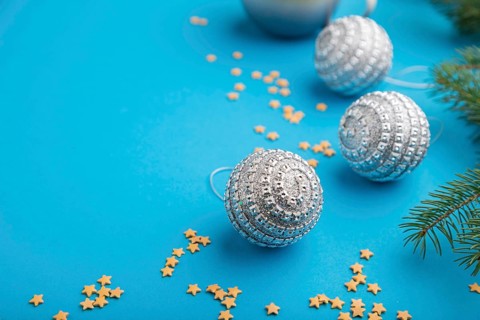 Christmas or New Year composition. Decorations, silver balls, fir and spruce branches, cup of