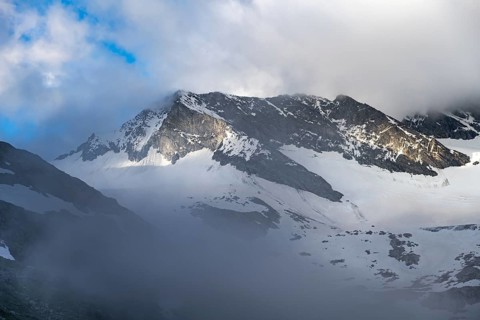 Cloudy glaciated summit Dosso Largo with glacier Schlegeiskees, Berliner Höhenweg, Zillertal Alps,