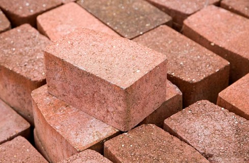 Clay bricks piled up in builder's yard, UK
