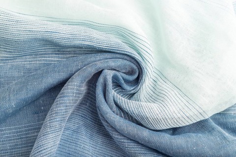 Fragment of blue linen tissue. Top view, natural textile background and texture. wave concept,