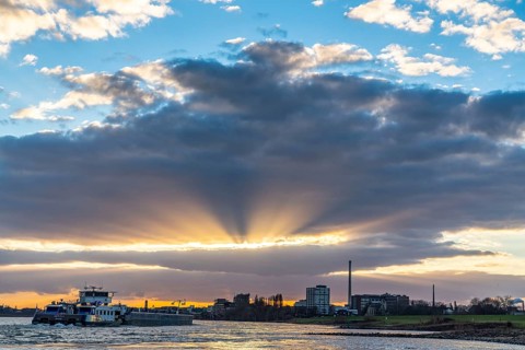 Cargo ship on the Rhine between Duisburg and Krefeld, dramatic sunset, North Rhine-Westphalia,
