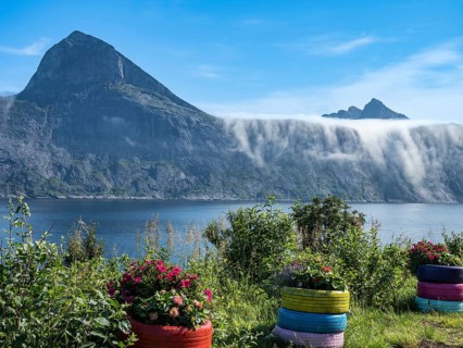 View from rest area over fjord Mefjord on Senja island, in the background the peaks of famous Segla