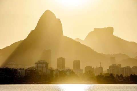 Sunset at the Rodrigo de Freitas lagoon in the city of Rio de Janeiro with the Gavea stone and Two
