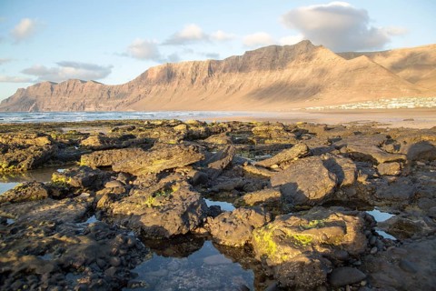 Lanzarote, Canary islands, SpainLate afternoon light on beach and cliffs La Caleta de Famara,