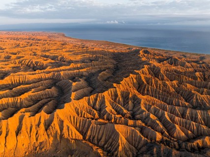 Landscape of eroded hills at Lake Issyk Kul, Badlands at sunrise, aerial view, Canyon of the