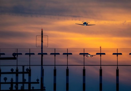 Runway lighting, approach aids, at Düsseldorf International Airport, sunset, aircraft taking off