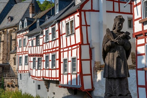 Monreal, idyllic half-timbered village in the Elz valley, figure of Nepomuk, the bridge saint, in