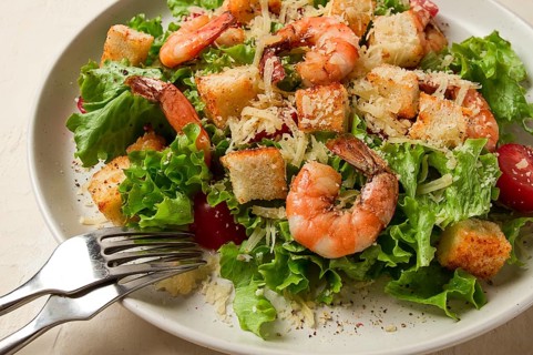 Caesar salad, with shrimp, on a white background, homemade, no people