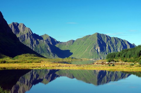 Mountains reflected in the water of an inlet, Leknes, Vestvagoy, Lofoten, Nordland, Norway, Europe