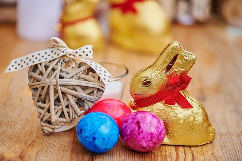 Decoration with colourful eggs and golden chocolate bunnies for easter, Germany, Europe