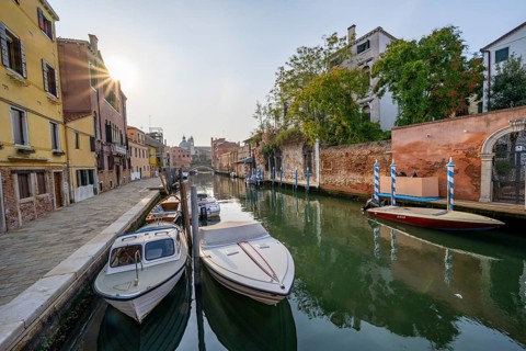 Motorboats and colourful house facades on a small canal, Sun Star, Venice, Veneto, Italy, Europe