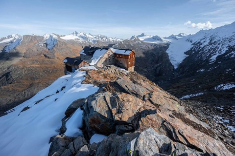 Snowy mountain landscape, mountain hut Ramolhaus in autumn with snow, in the evening light, view of