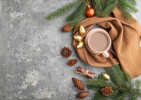 Christmas or New Year composition. Decorations, cones, cinnamon, fir and spruce branches, cup of