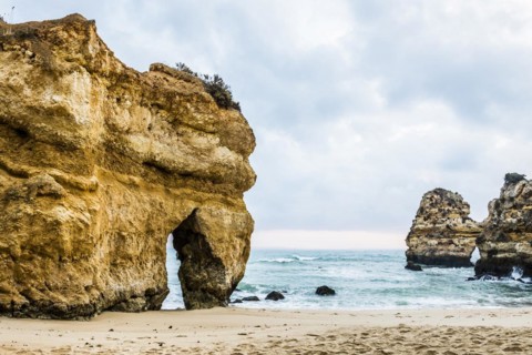 Rocky coast with beach and red rocks, Praia do Camilo, Lagos, Algarve, Portugal, Europe