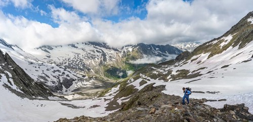 Mountaineer on hiking trail with snow, mountain landscape with summit Hoher WeiÃŸzint and