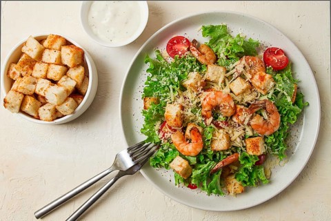 Caesar salad, with shrimp, on a white background, homemade, no people