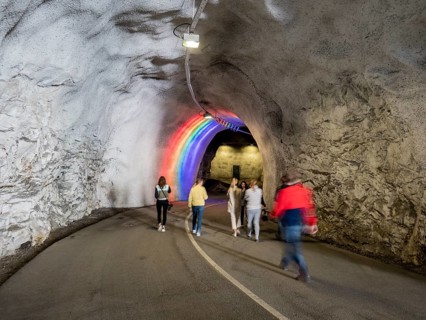 Colorful illuminated tunnel for bicycles and pedestrians leads up to Hardanger suspension bridge,