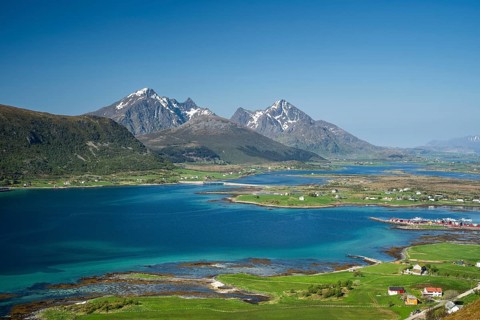 Landscape with sea and mountains, view from Hornsheia to Mount Himmeltindan. Good weather, blue sky