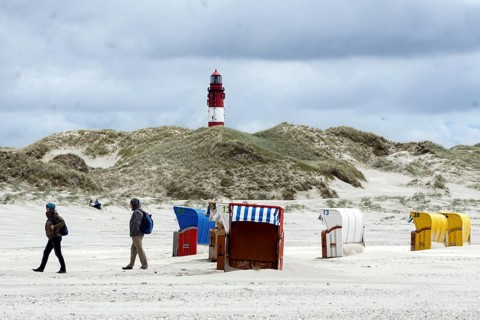 Lighthouse on the island of Amrum, beach chairs on the sandy beach, 27.05.2021